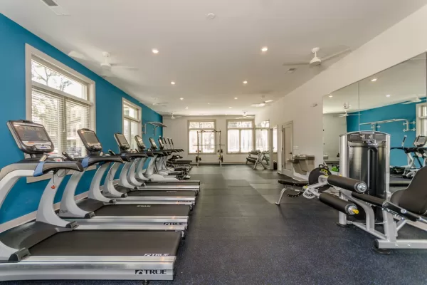 Fitness center filled with a variety of workout equipment and machines
